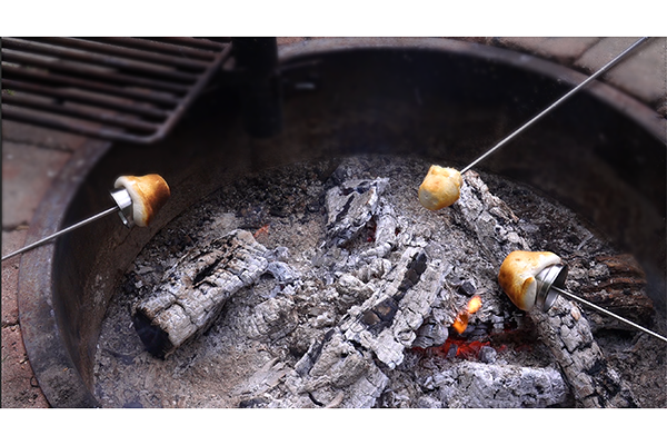 Roast campfire biscuit cups on a variety of types of sticks.