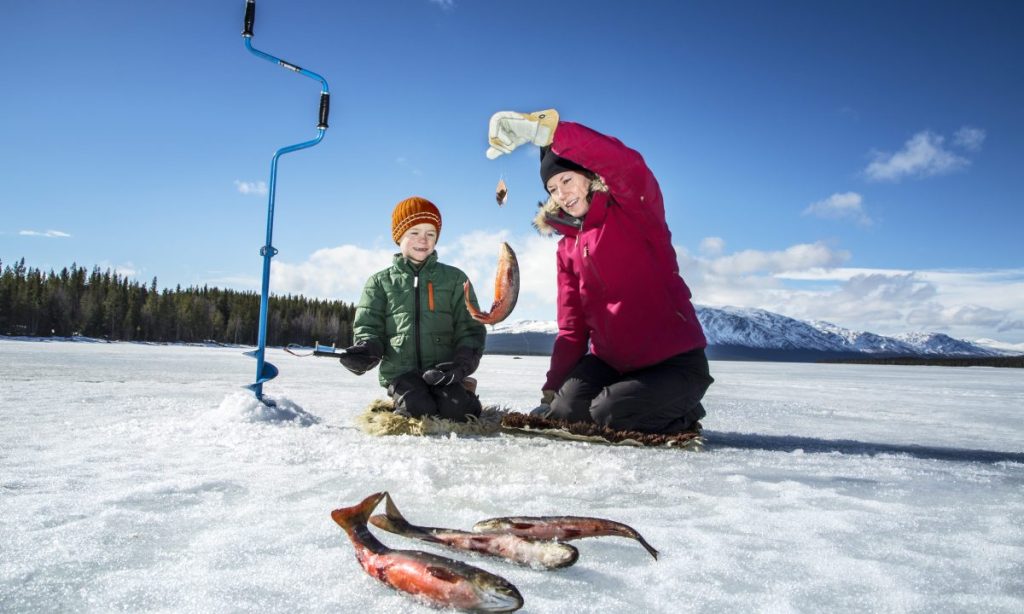 Mother with son ice fishing