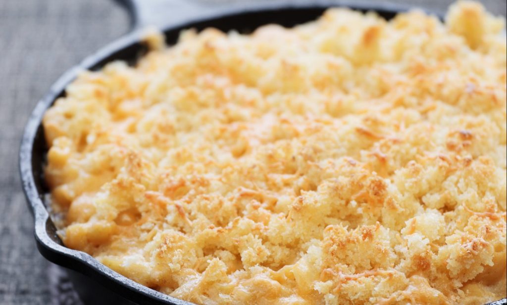 Macaroni and cheese baked in a cast iron skillet.