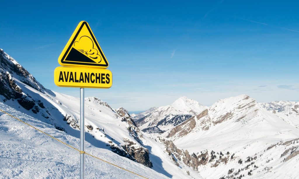 A sign warning of avalanche risk in the European Alps during winter.