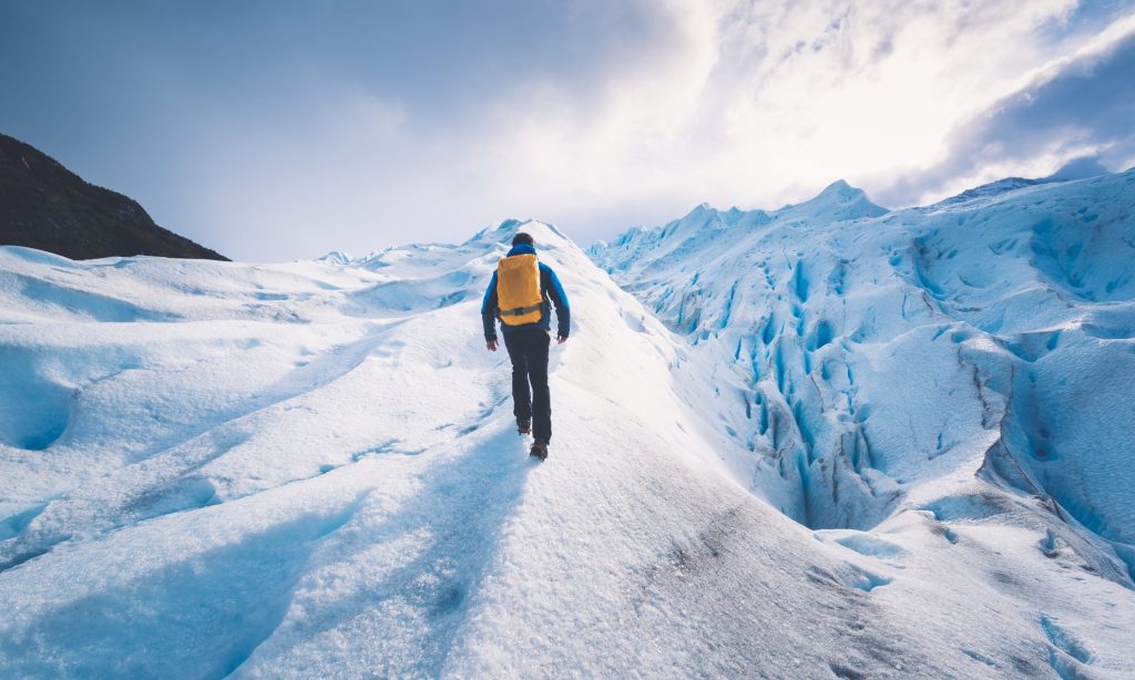 One person hiking on the ice field of the Perito Moreno glacier