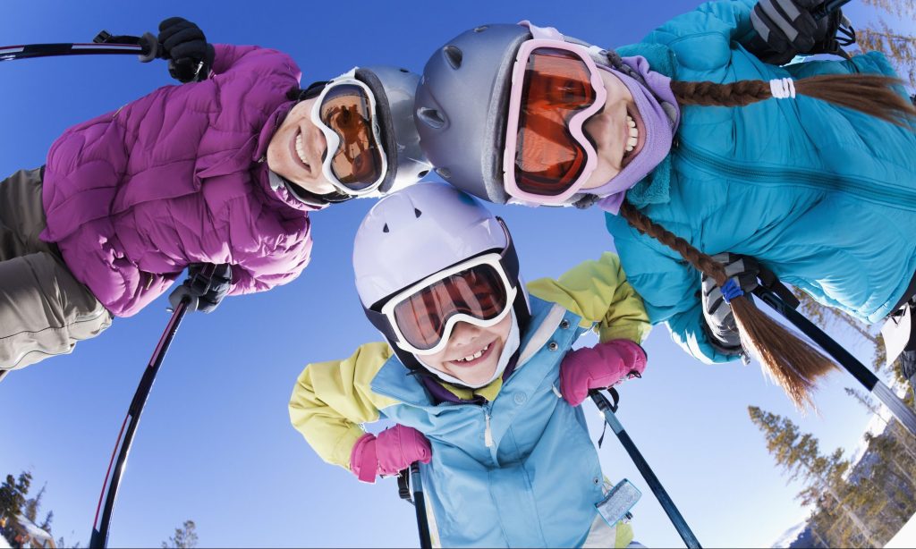 Grinning family skiing together Grinning family skiing together