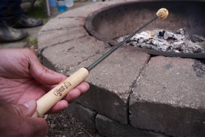 There are a variety of campfire biscuit cup roasting sticks on the market. This is a Cobbler's Stick.