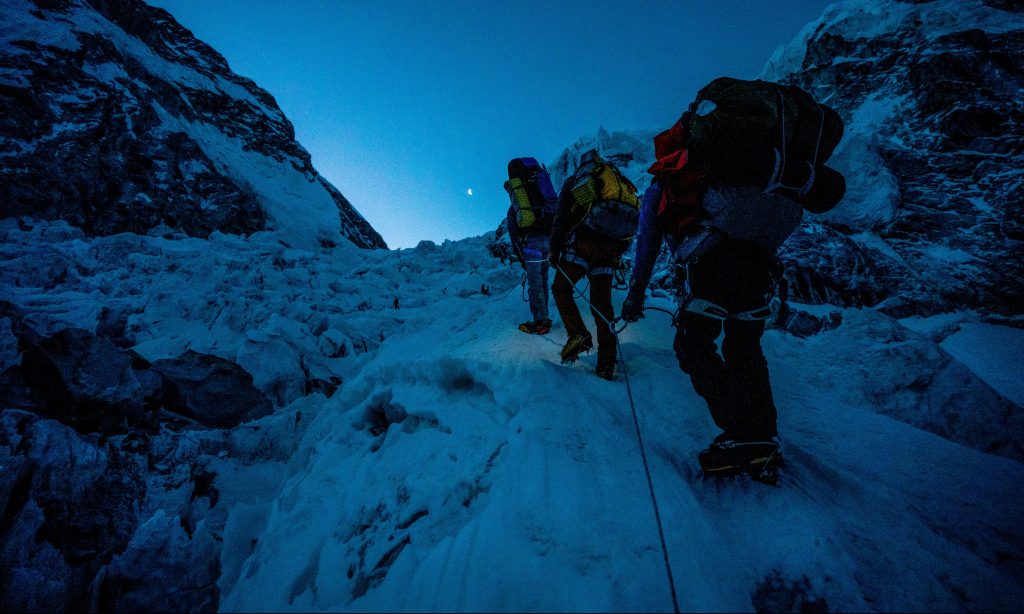 Finding Michael
The Expedition team climbing through the Khumbu Ice fall at first light. 
Photo by Brodie Hood.
Courtesy of Disney+ © 2022.