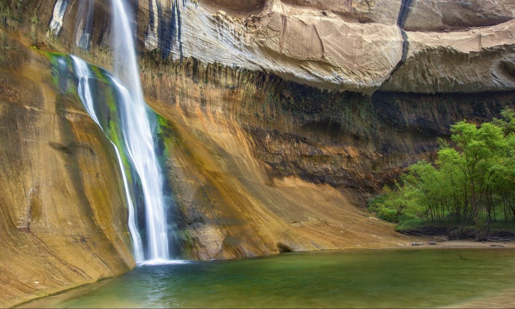 Lower Calf Creek Falls is a 126-foot waterfall located in the middle of the Utah desert. This beautiful riparian oasis is part of the Grand Staircase Escalante National Monument.