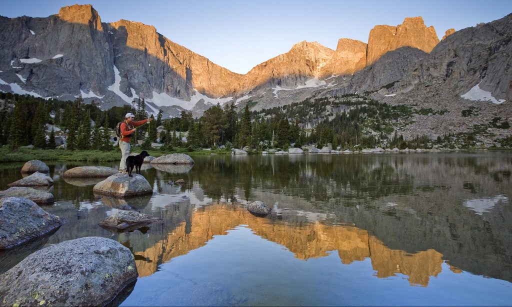 A male fly fisherman in a lake below the Cirque of the Towers, Wind River Range, Wyoming.
