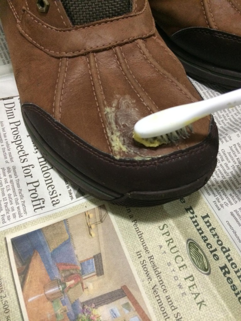 Dip your toothbrush in the melted wax, and brush it on the leather until it's all covered. Try not to get it on suede or fabric though. 