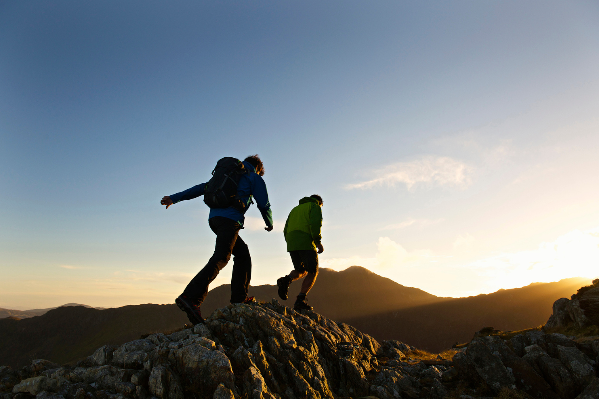 Hikers on a trail with a backpack cooler